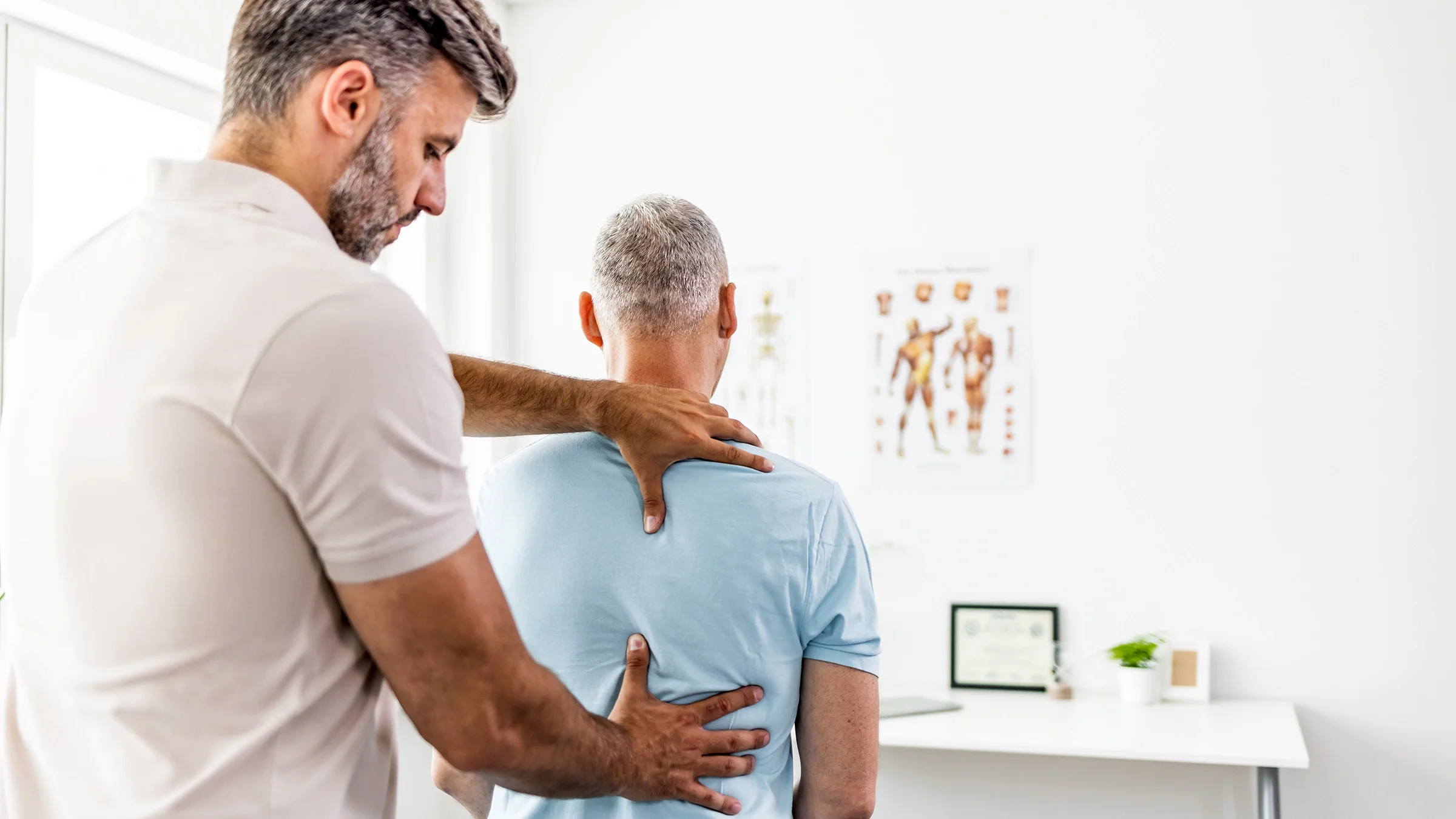 A patient receives a chiropractic back adjustment.