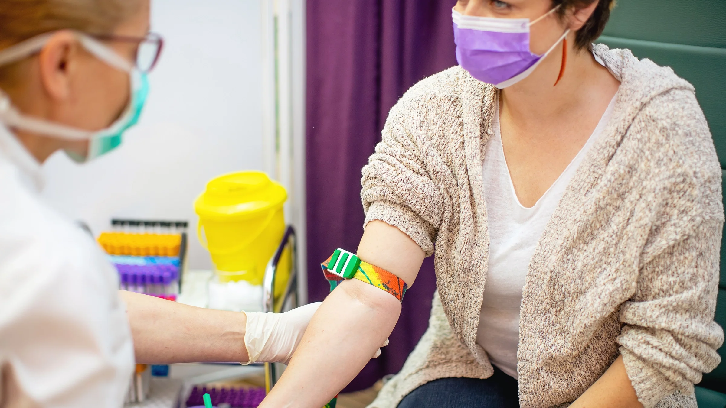 A cropped shot of a phlebotomist prepping to draw blood.