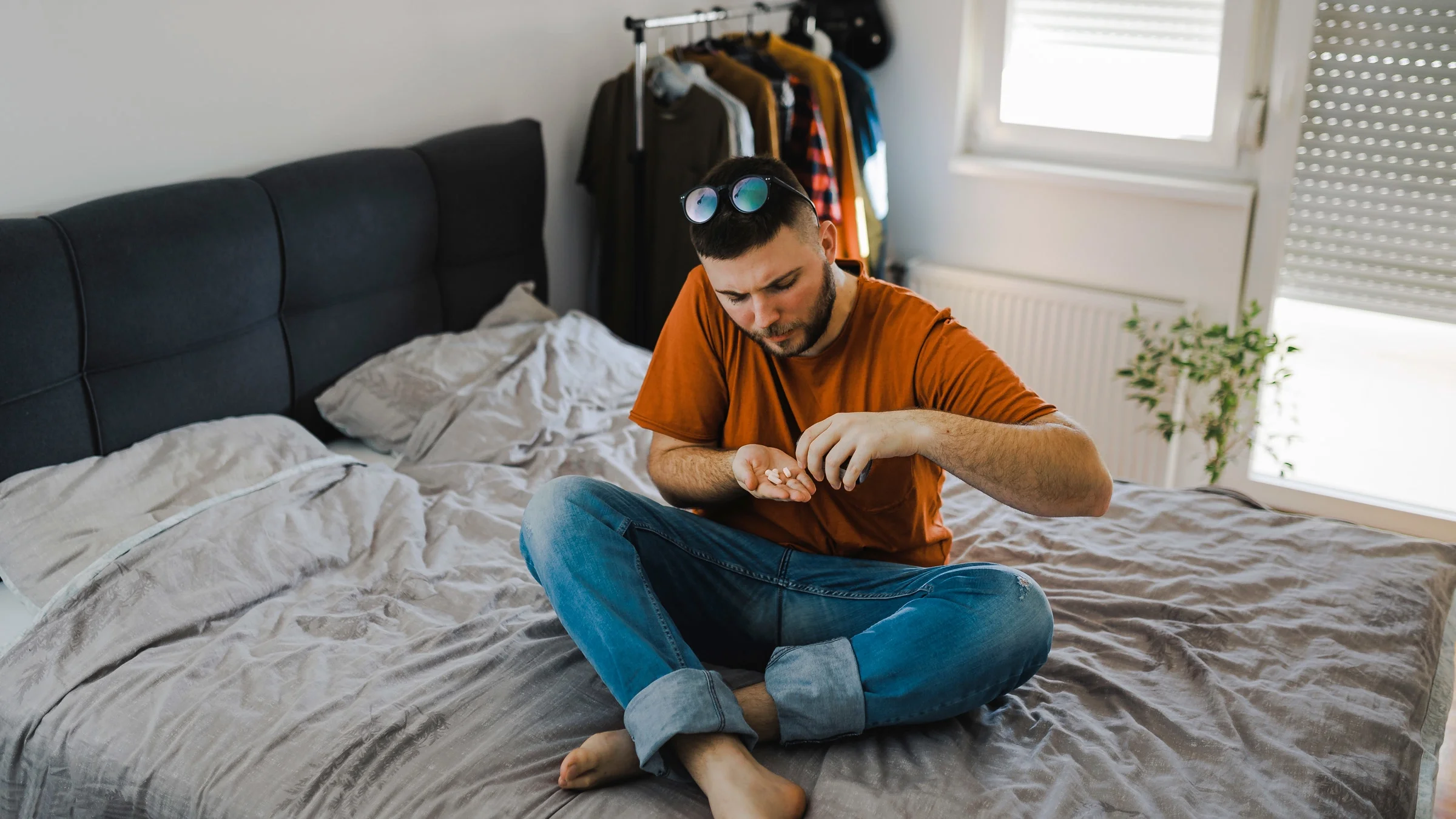 Taking pills on bed.