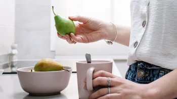 Alcohol: closeup woman holding a pear 1386664125