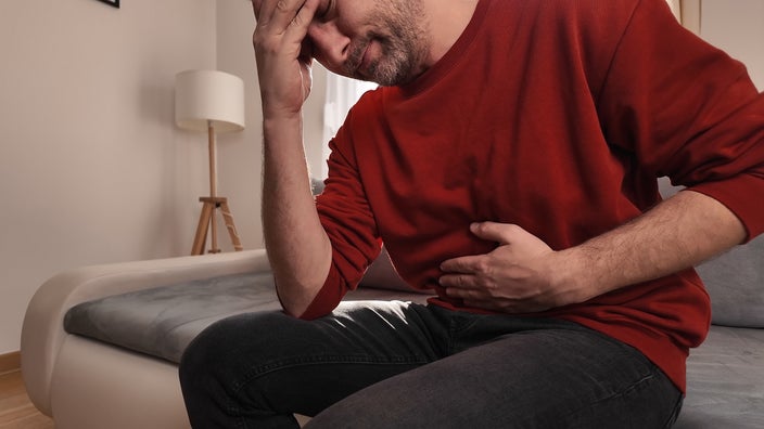 A man seems to be having abdominal pain.