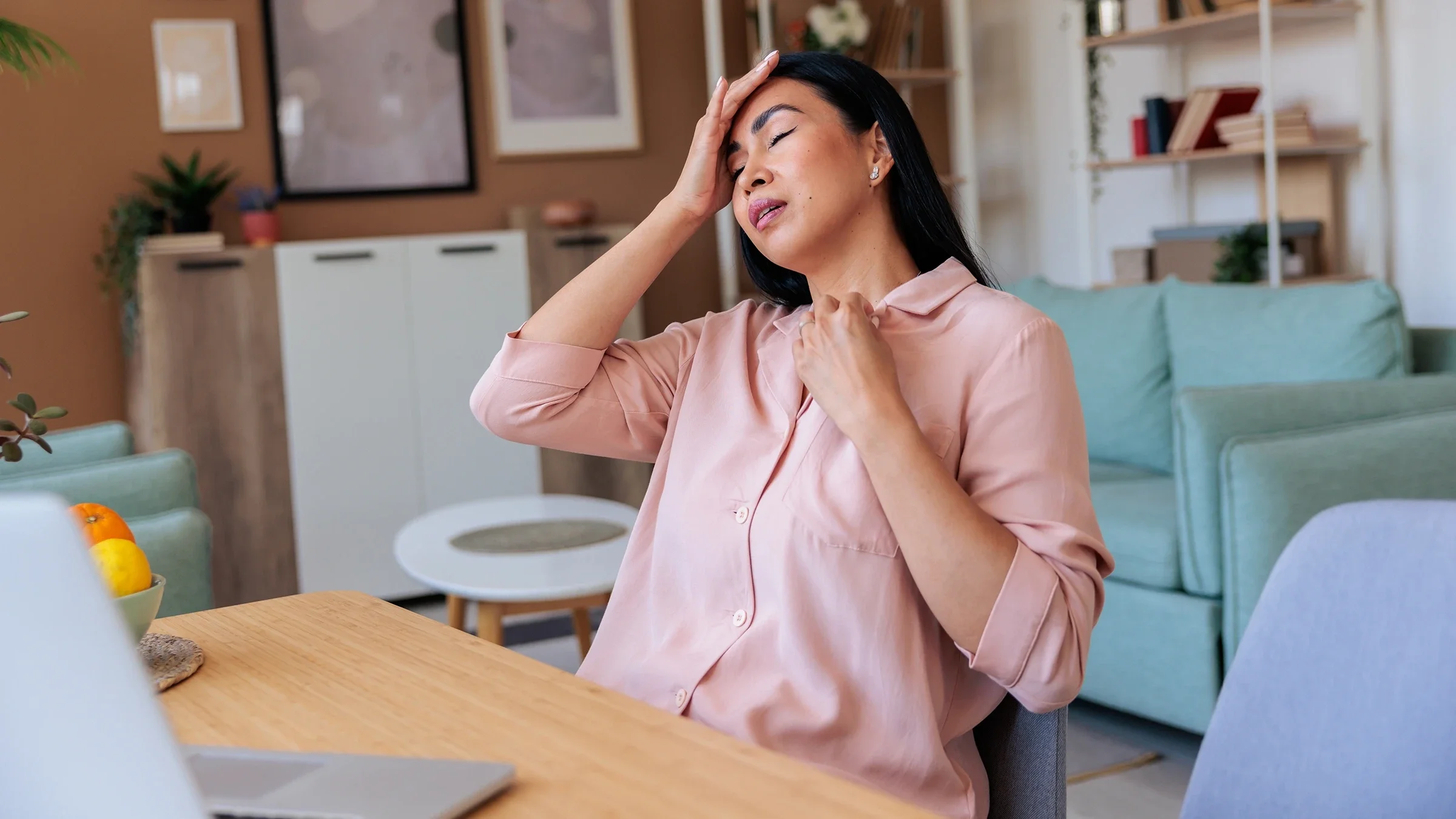 A woman appears to be having a hot flash.