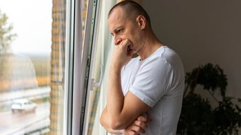 Mental-health: man looking out the window 1354862513