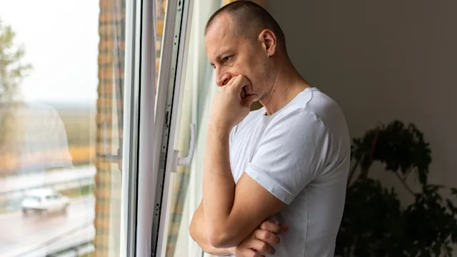 Mental-health: man looking out the window 1354862513