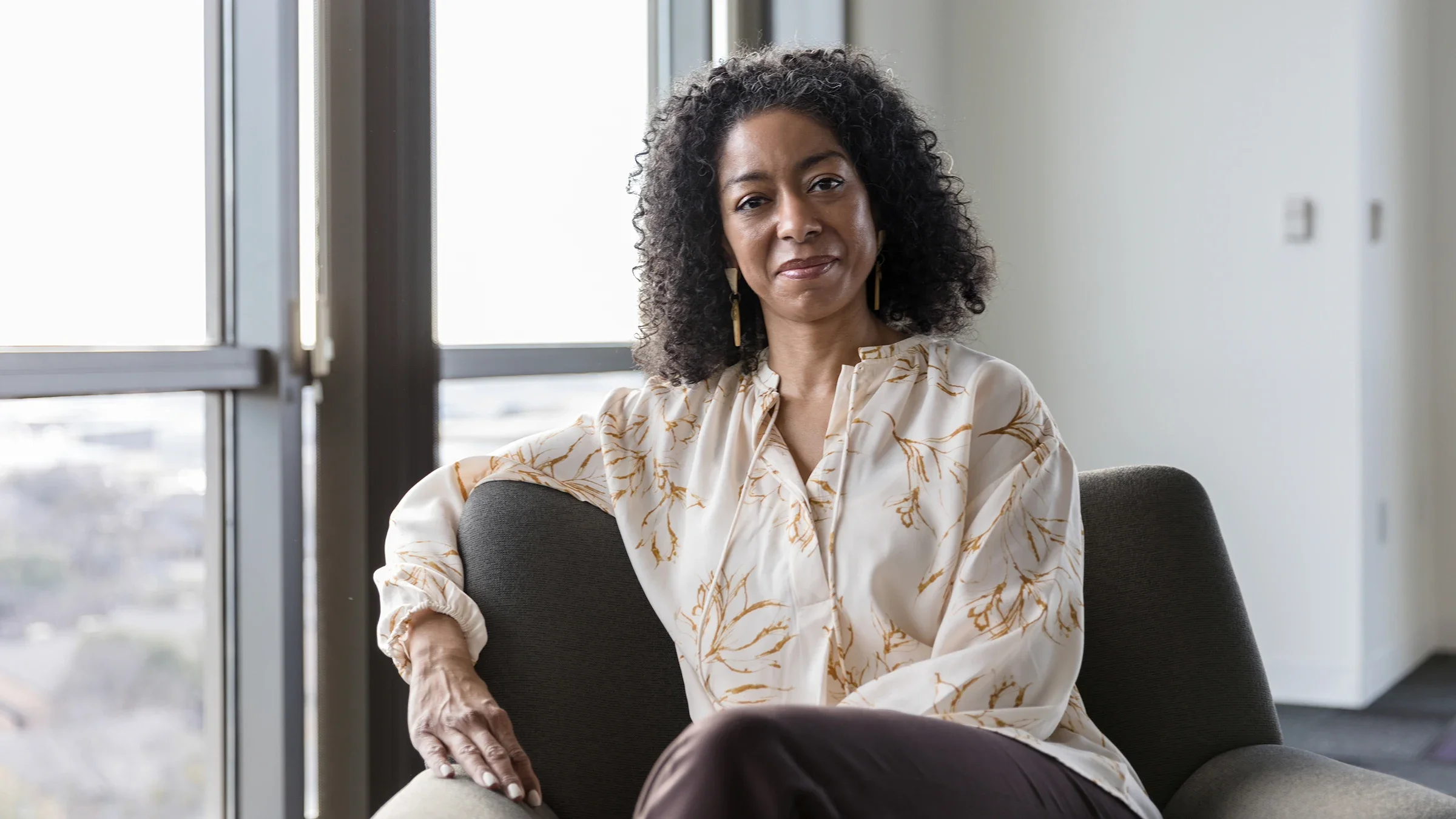Portrait of a Black woman in her office. She is sitting relaxed on a cushy chair.
SDI Productions/E+ via Getty Images
