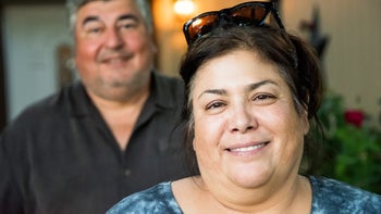 portrait of woman with husband in background-809693968