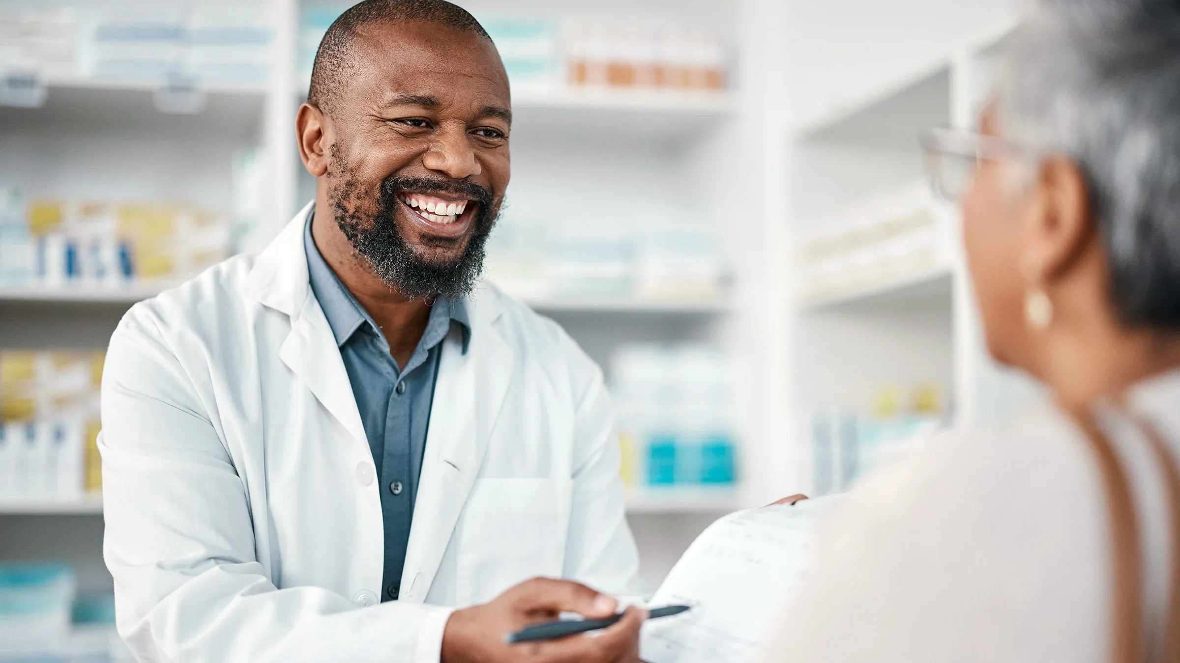 A pharmacist speaks to a customer.
PeopleImages/iStock via Getty Images Plus