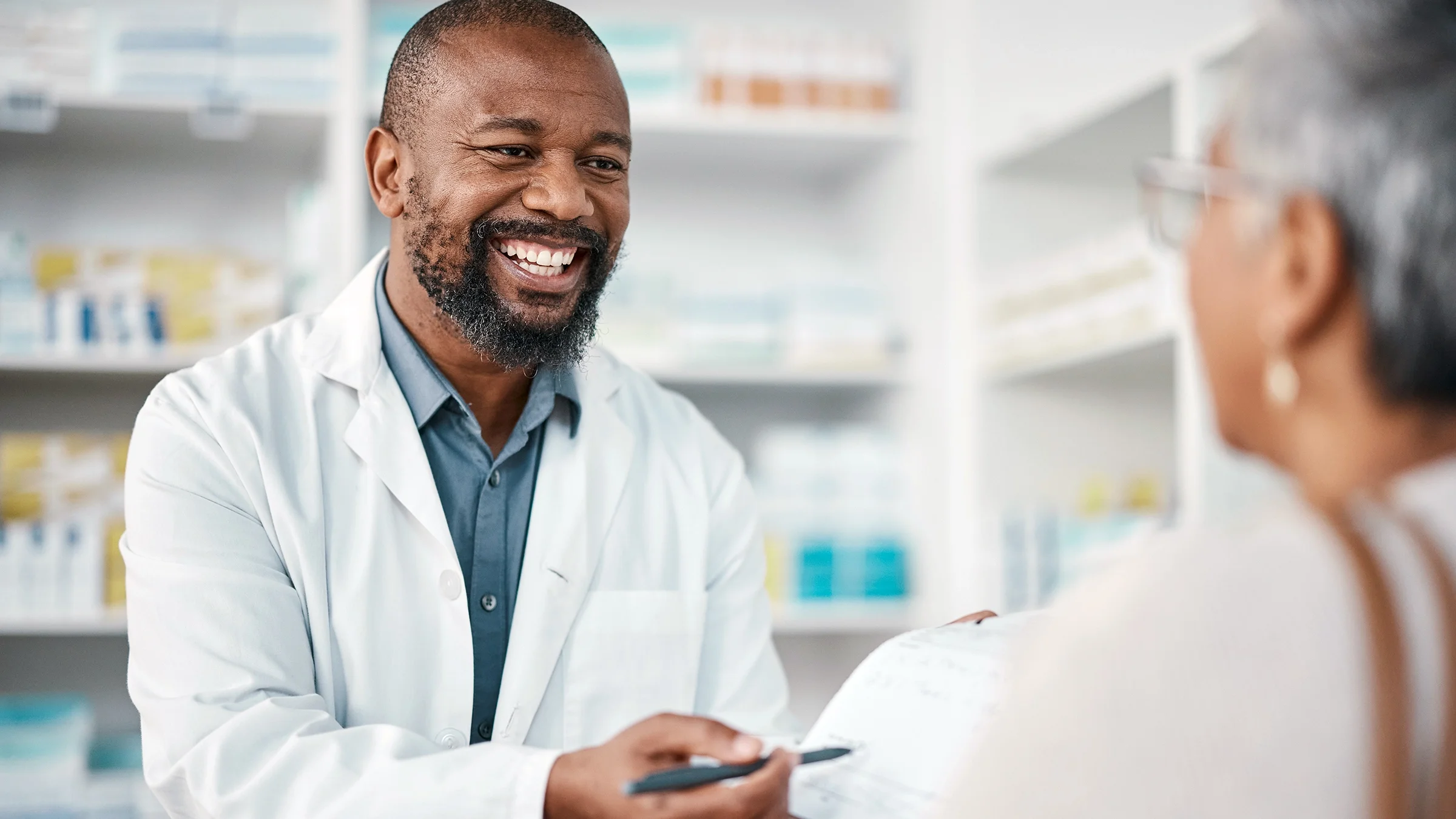 A pharmacist speaks to a customer.