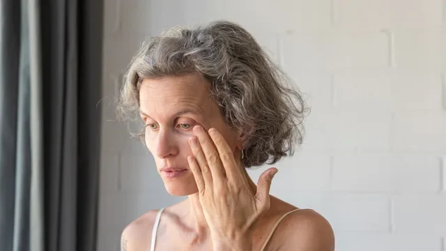 menopause: eye: vision: older woman eye pain 1132208914