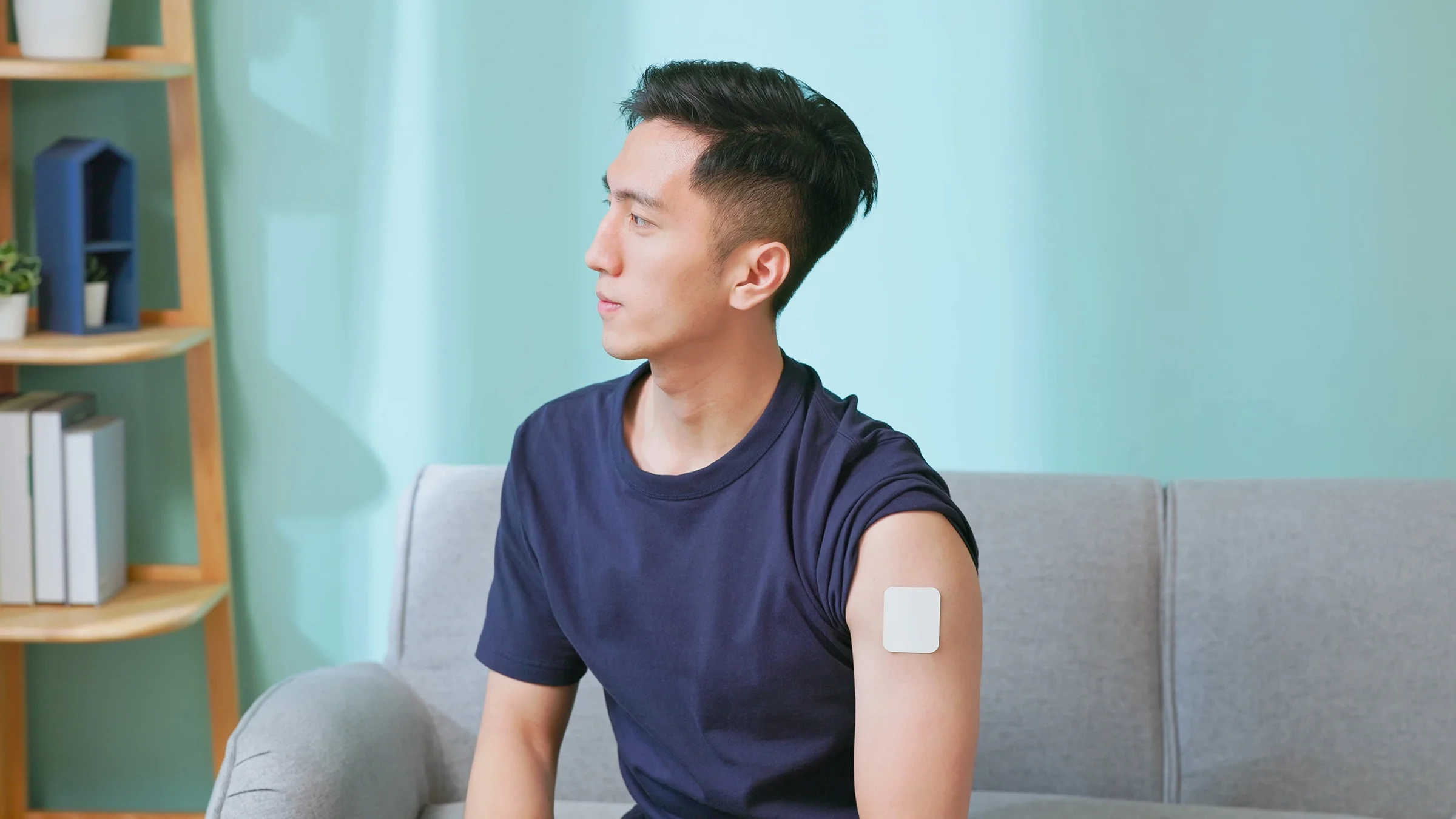 Man wearing nicotine patch on his arm.