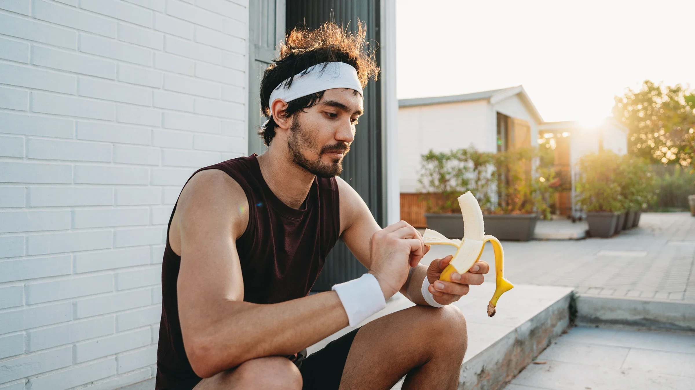 A man peels a banana after exercising outdoors.
FilippoBacci/E+ via Getty Images       