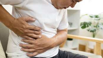 hepatitis-c: pain: man abdominal pain right side GettyImages-1345447265