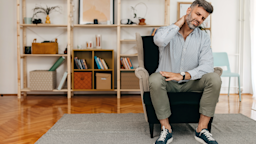 A man is sitting on a sofa and suffering from neck pain.
supersizer/E+ via Getty Images 