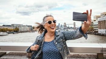 senior woman selfie while traveling-1179623849