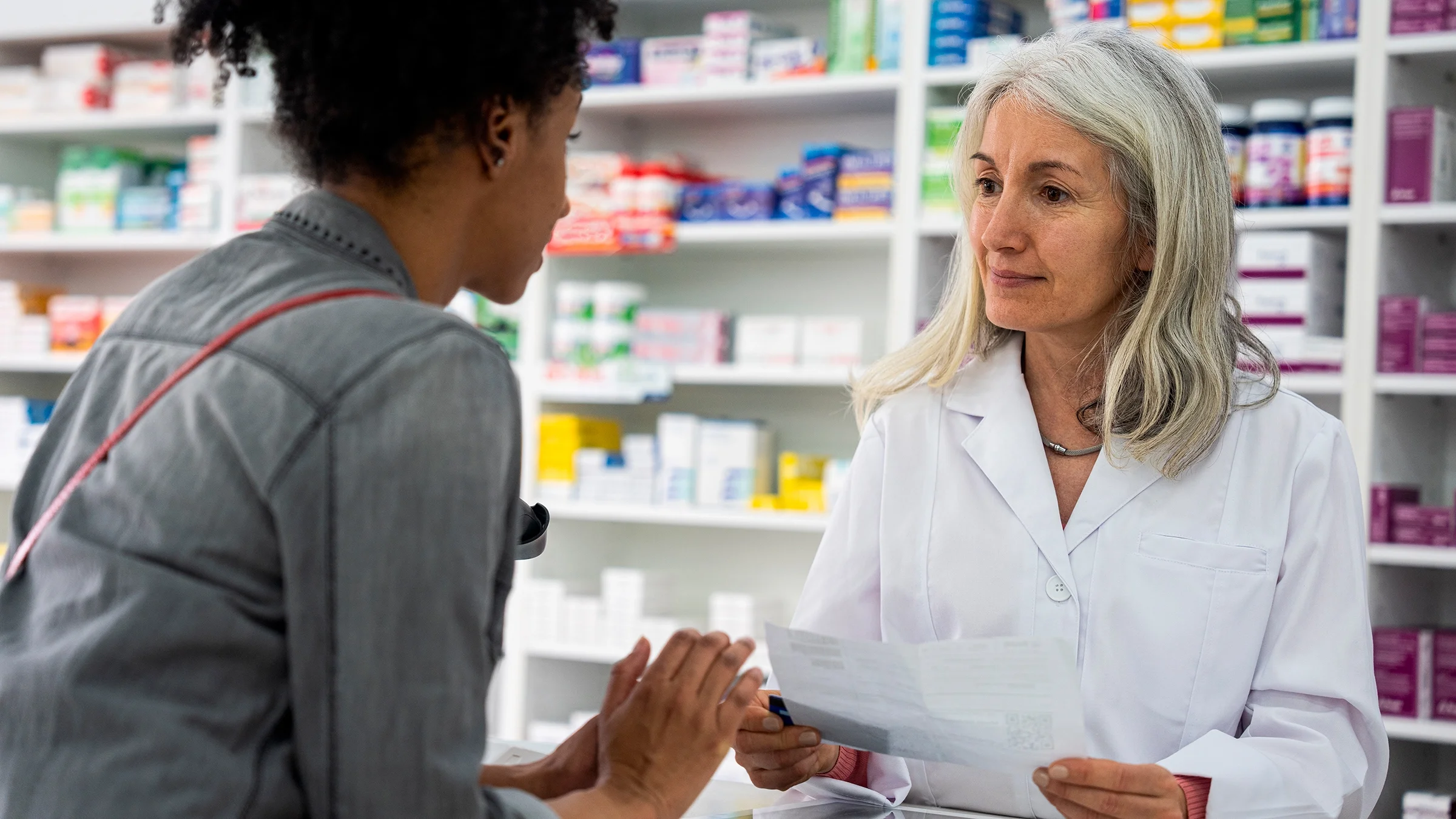 A pharmacist helps a customer.