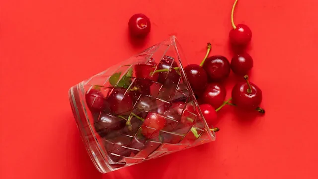 sleep: cherries in glass on red background 1460164146