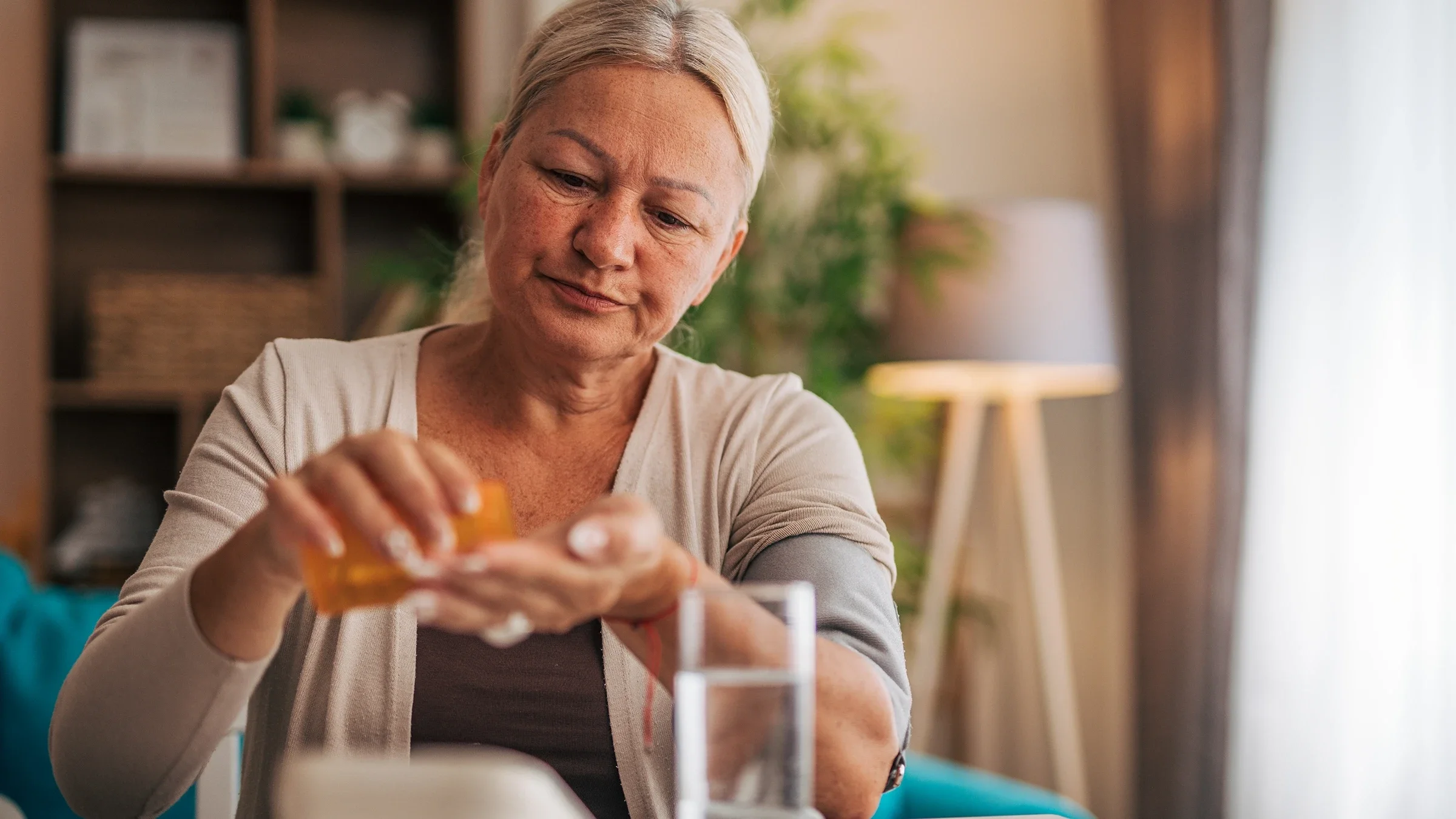 Woman taking medication at home.