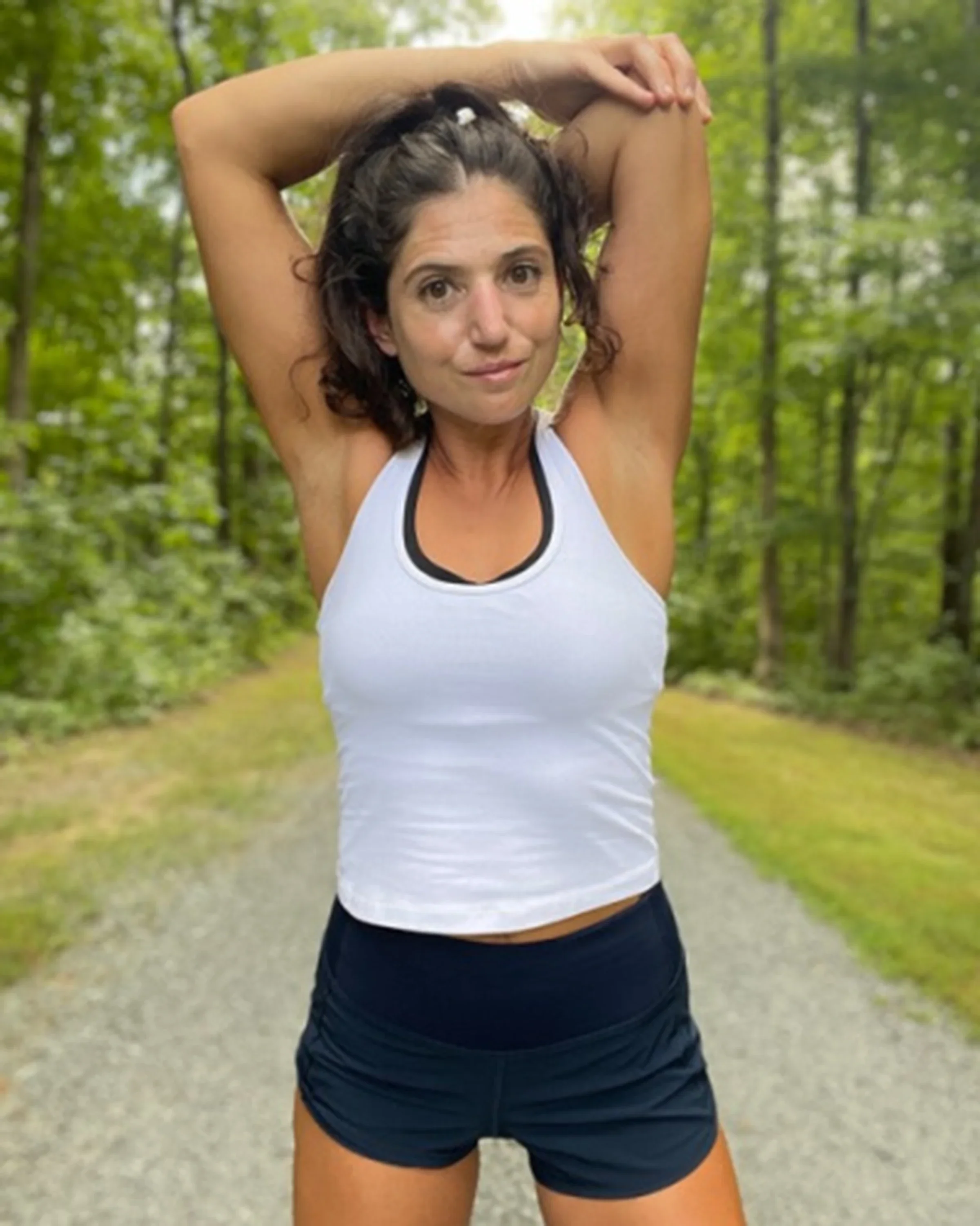 Samantha Salvaggio is pictured in her workout gear, stretching.