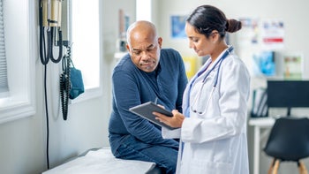 weight loss: man speaking to healthcare professional 1938542779