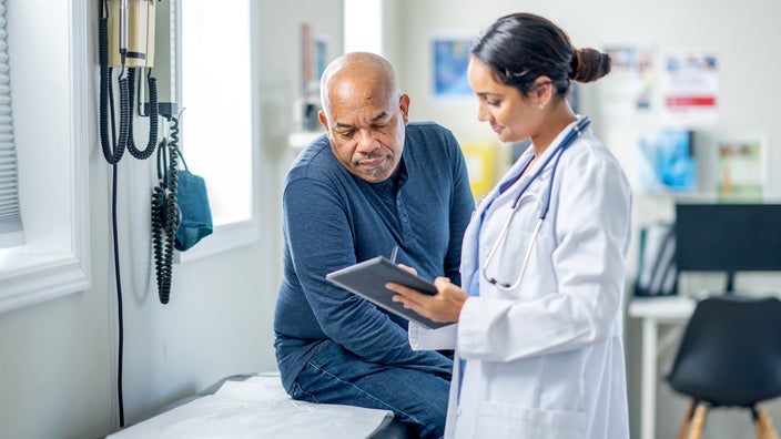 Man speaking to healthcare professional at an appointment.