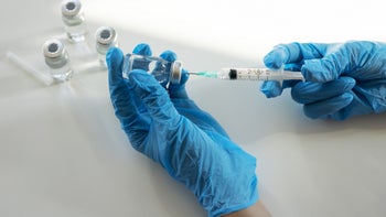 biologics: closeup preparing syringe for injection 2098817477