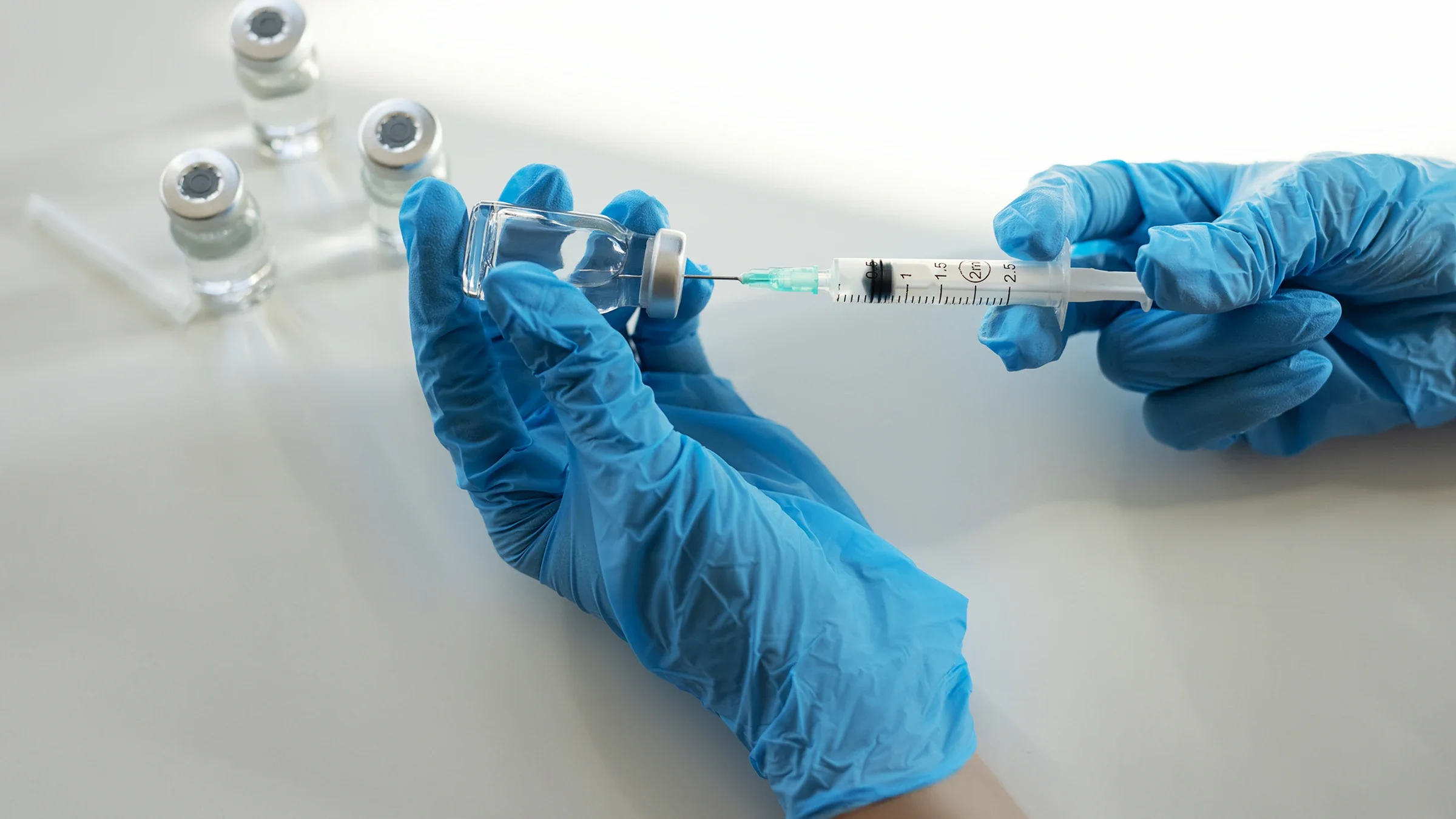 A medical professional prepares a syringe for injection.
bymuratdeniz/E+ via Getty Images  