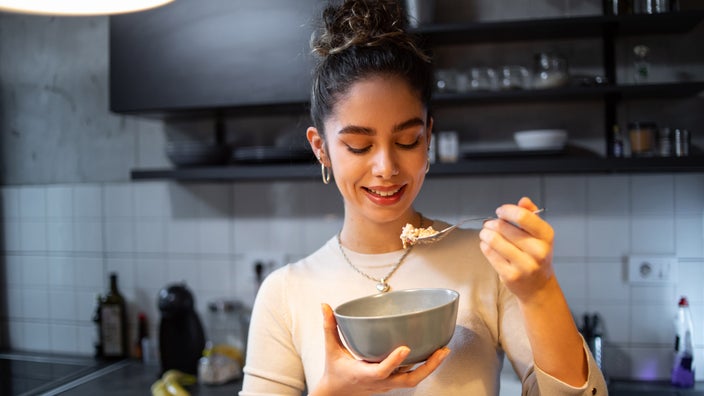 A person eating oatmeal.