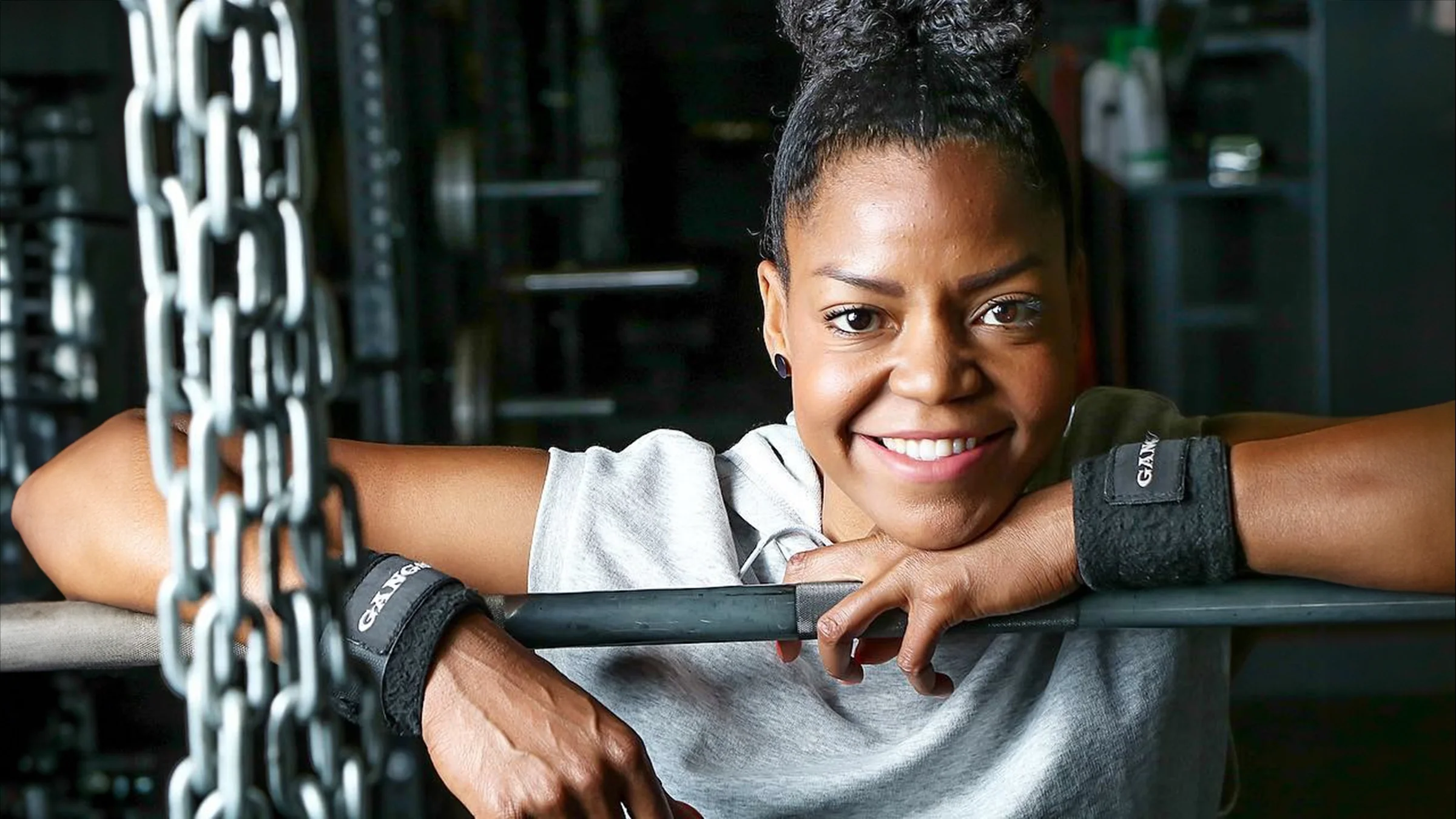 Chrissy King is pictured at the gym with weightlifting equipment.