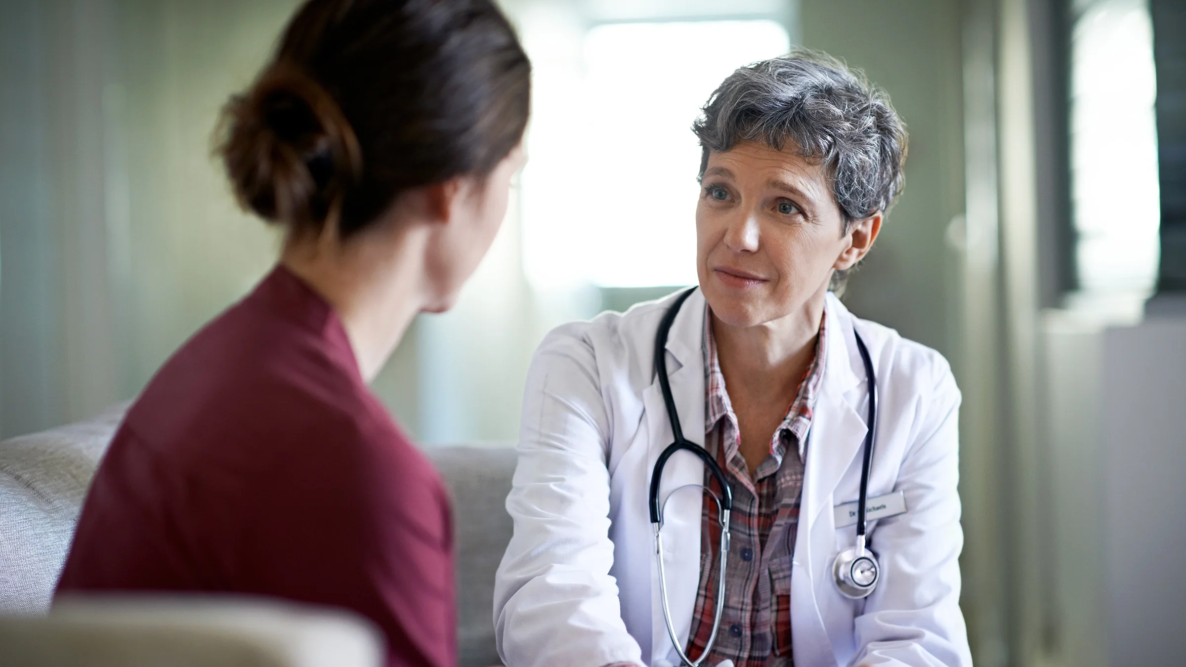 Healthcare professional speaking with a patient.