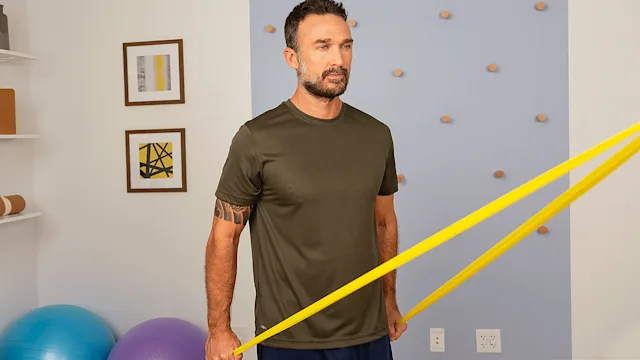 man doing shoulder extension with resistence band HERO 2400