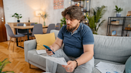 A man does paperwork at home.
urbazon/E+ via Getty Images