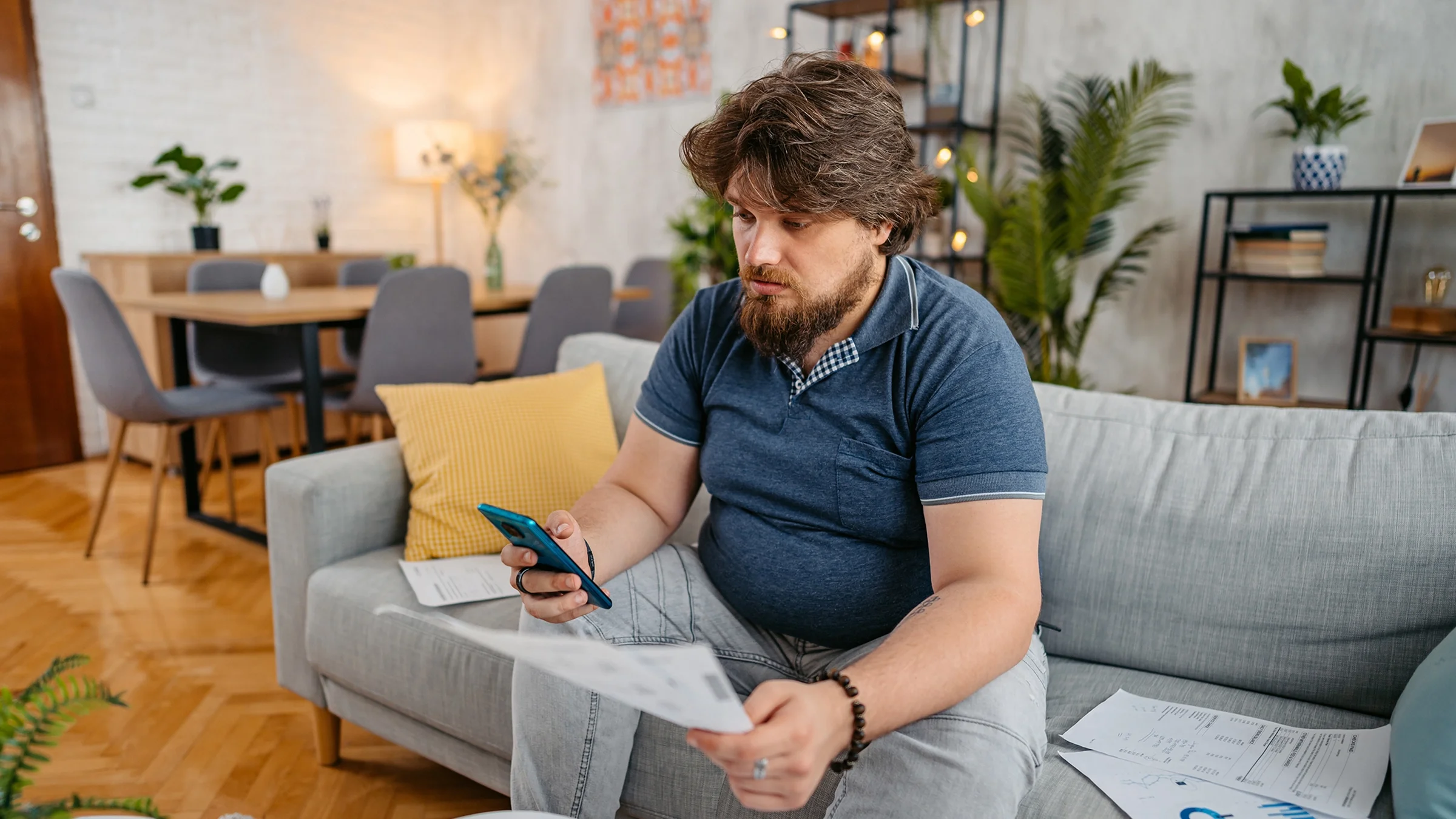 A man does paperwork at home.