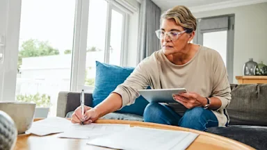 woman doing taxes in living room-1369745625