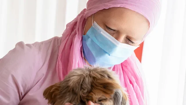Breast cancer: cancer patient hugging dog 1278567462