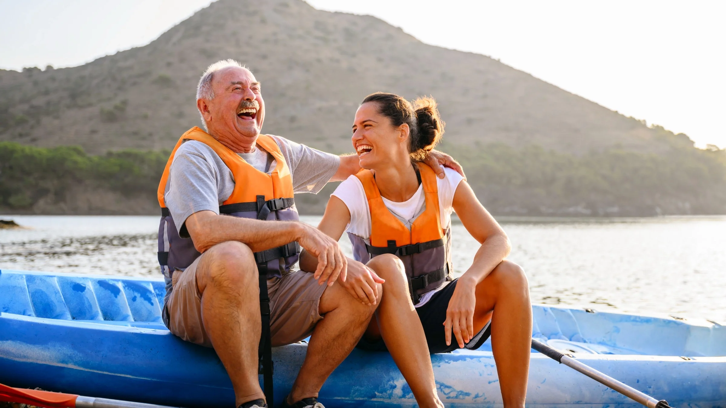 Father and daughter enjoying a day out kayaking on the water.
