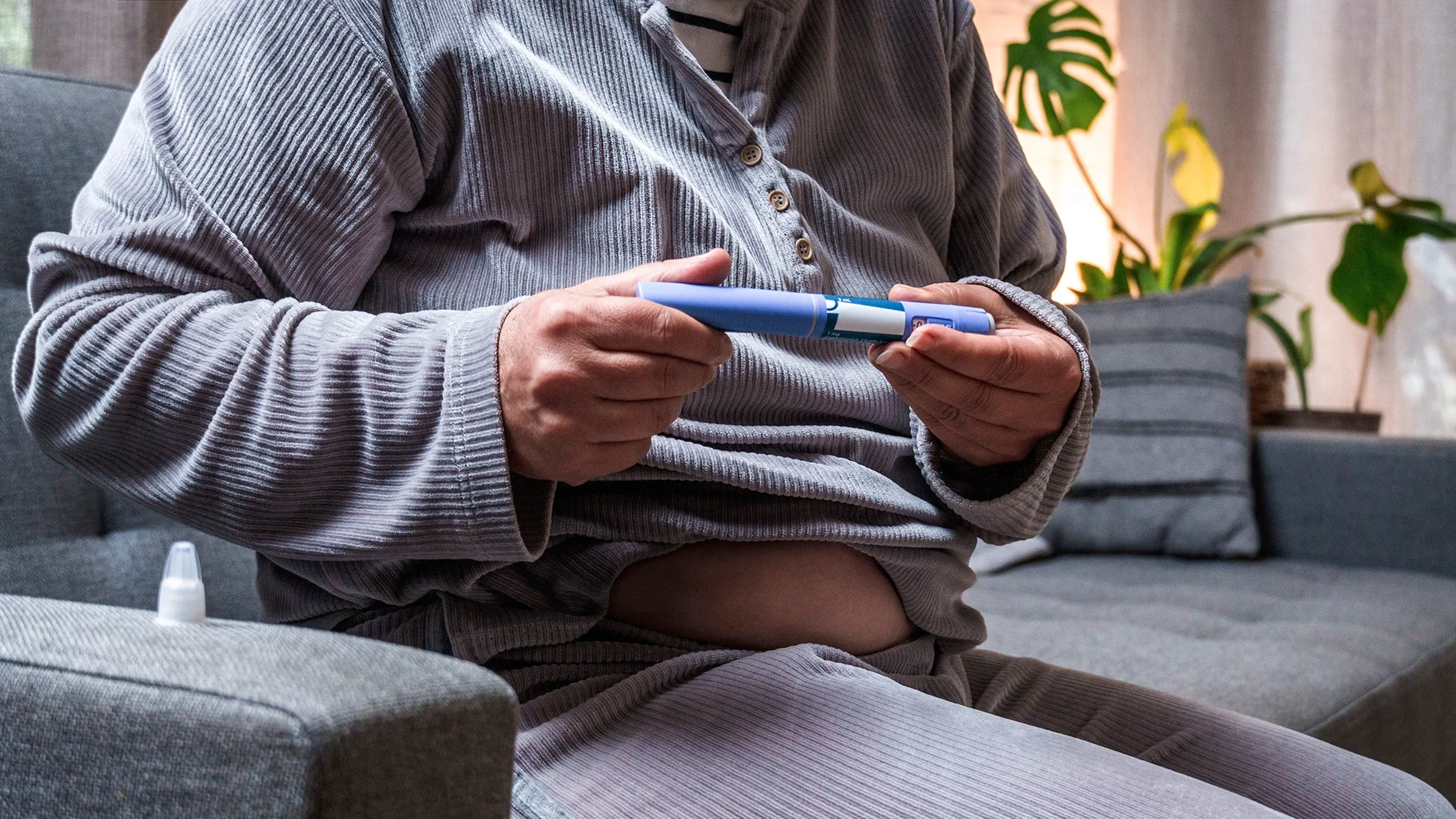 A person gets ready to self-inject semaglutide.