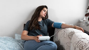 COVID-19: hypertension: sick taking blood pressure 1409480995