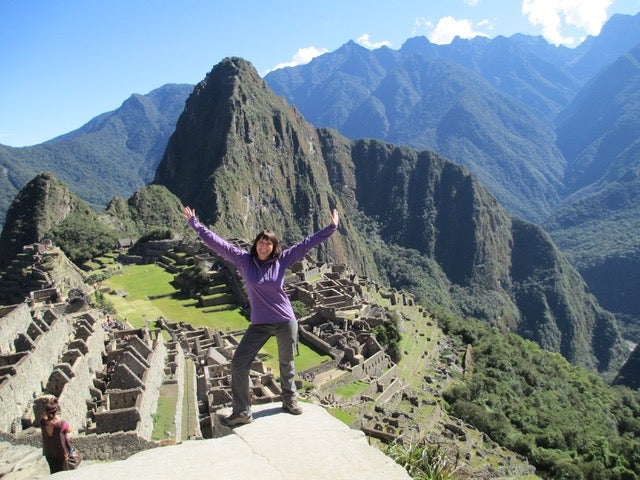 Lori Schneider posing at Machu Picchu.