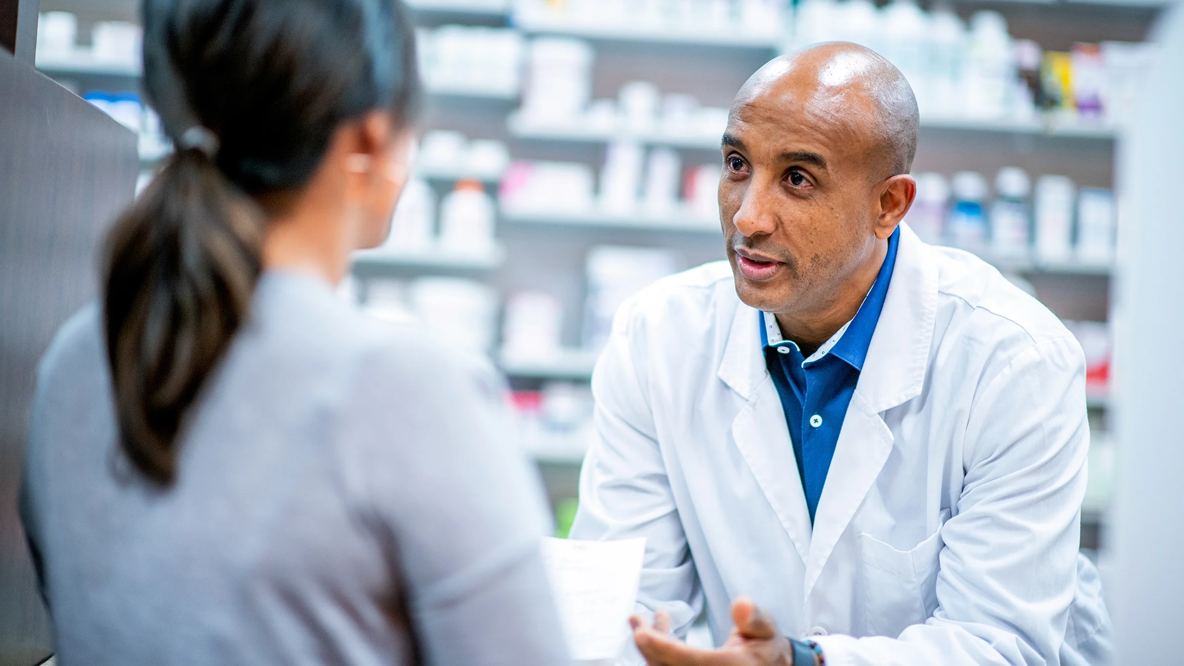 Pharmacist speaking to a patient.