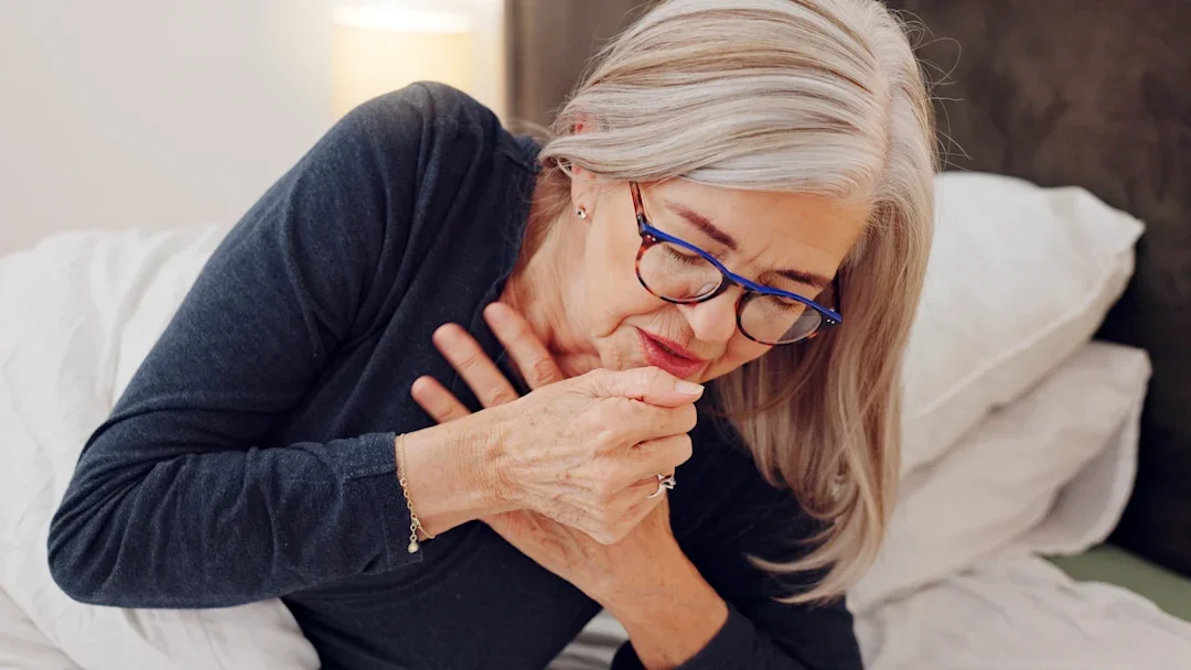 woman with cough symptons 1847512072