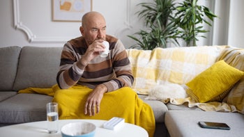 Diabetes: senior man sitting on couch 1389863573