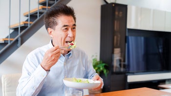 Health: Diet and nutrition: man eating salad at home 1499731066