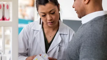 Medication Education: Pharmacists: customer asking pharmacist about medication 1165345340