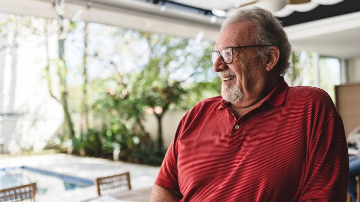 Portrait of a senior man in the backyard of home.