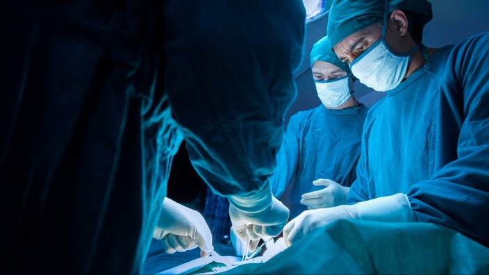 Surgeons performing a procedure in the operating room.