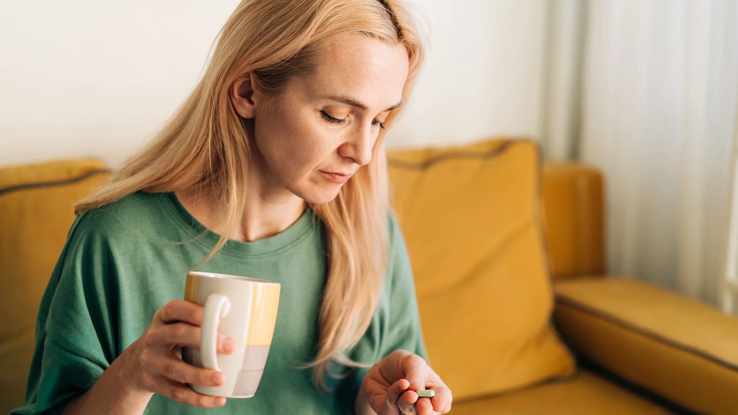 A woman prepares to take her medication.