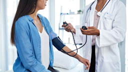 A woman gets her blood pressure measured during a checkup.
PeopleImages/iStock via Getty Images Plus