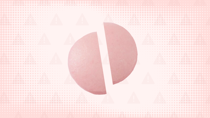 Pink background with texture and warning sign pattern. In the center is a round pink pill cut in half.