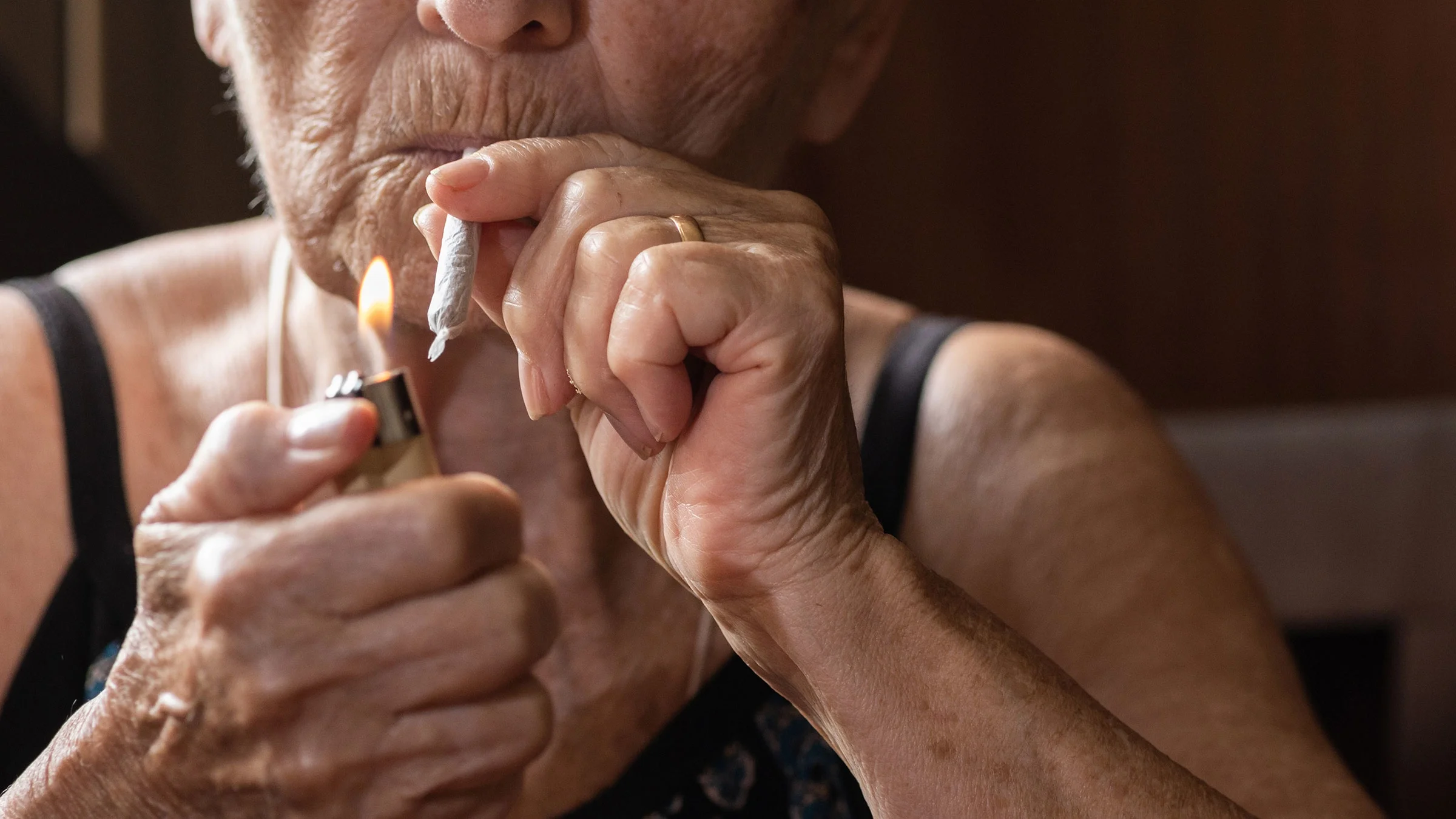 Close-up of a woman lighting a cannabis cigarette