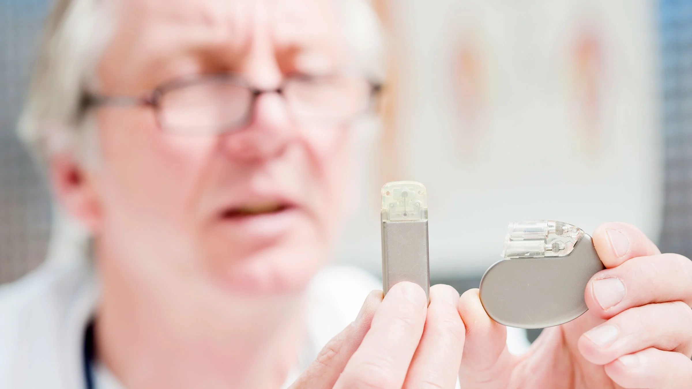 A doctor examining a pacemaker. 